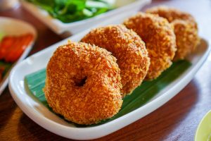 Delicious Thai-style fried shrimp cakes served on a banana leaf platter.
